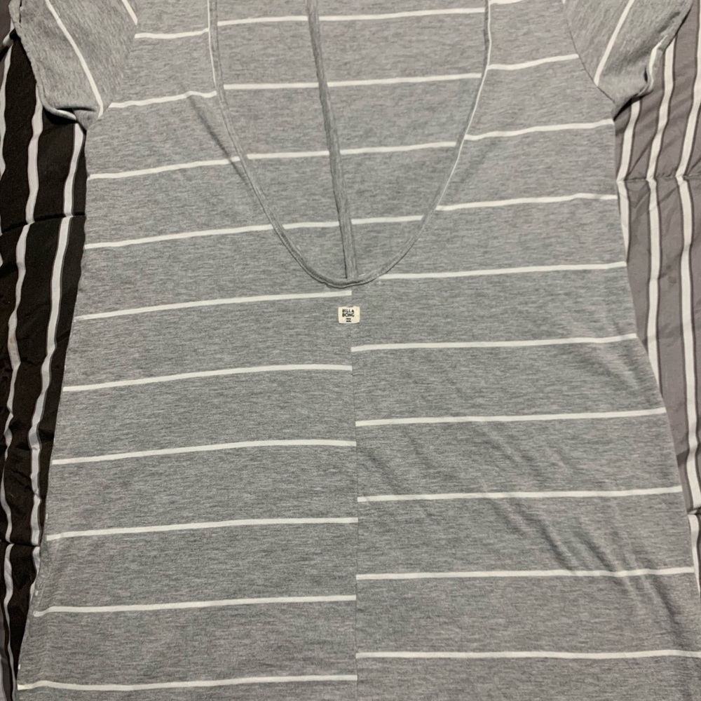 Lightly warn grey and white striped shirt. This shirt has a open back.